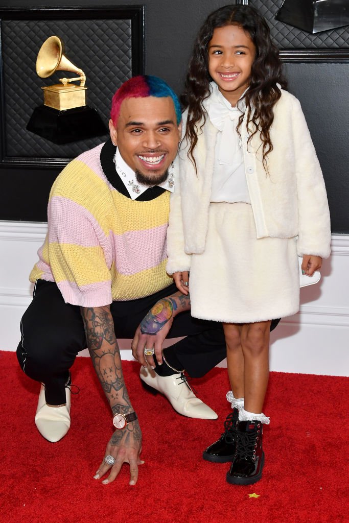 Chris Brown kneels down as he posed with his daughter Royalty Brown at the 62nd Annual GRAMMY Awards on January 26, 2020, in Los Angeles, California | Source Amy Sussman/Getty Images