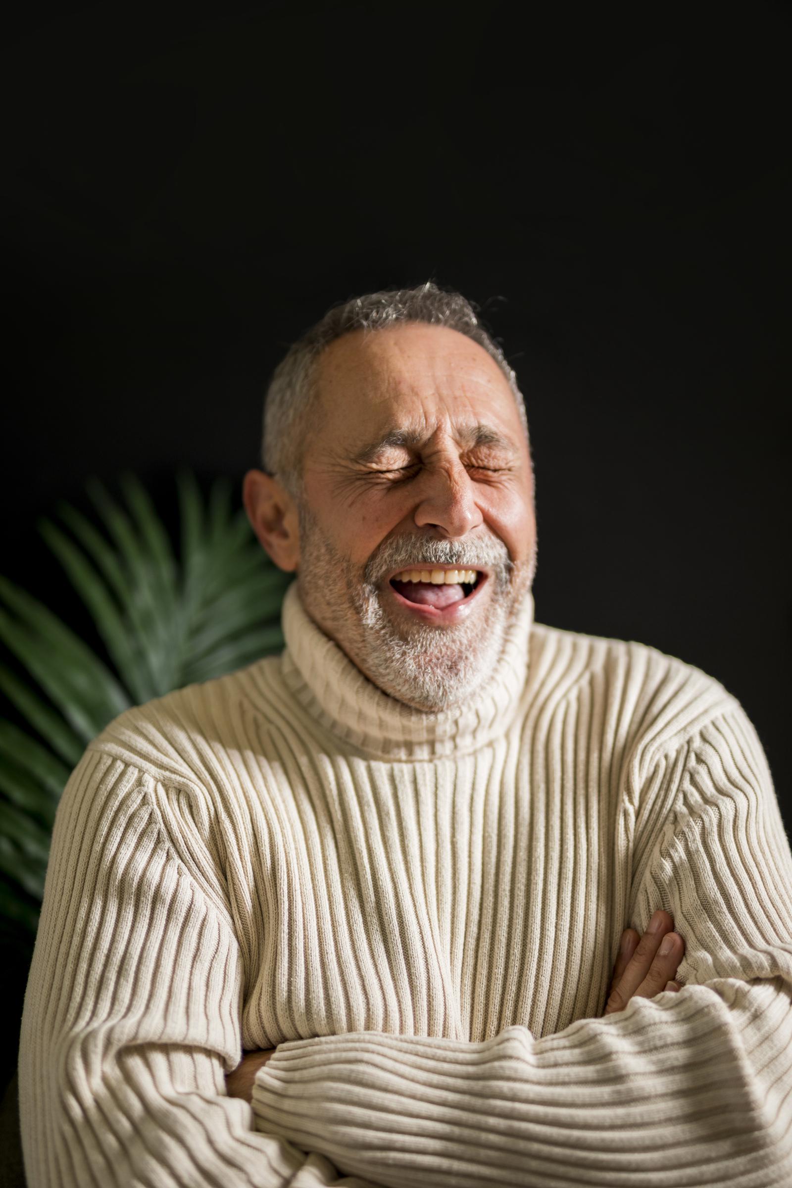 A senior man laughing | Source: Freepik