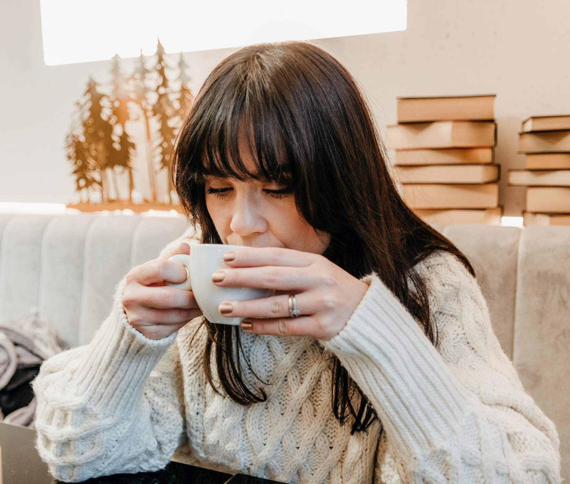 A woman drinking a cup of beverage | Source: Pexels