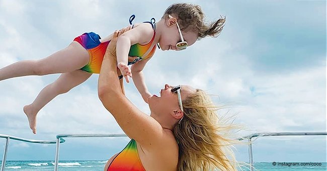 Coco Austin Lifts Her Mini-Me Daughter in the Air as They Flaunt Matching Rainbow Swimsuits