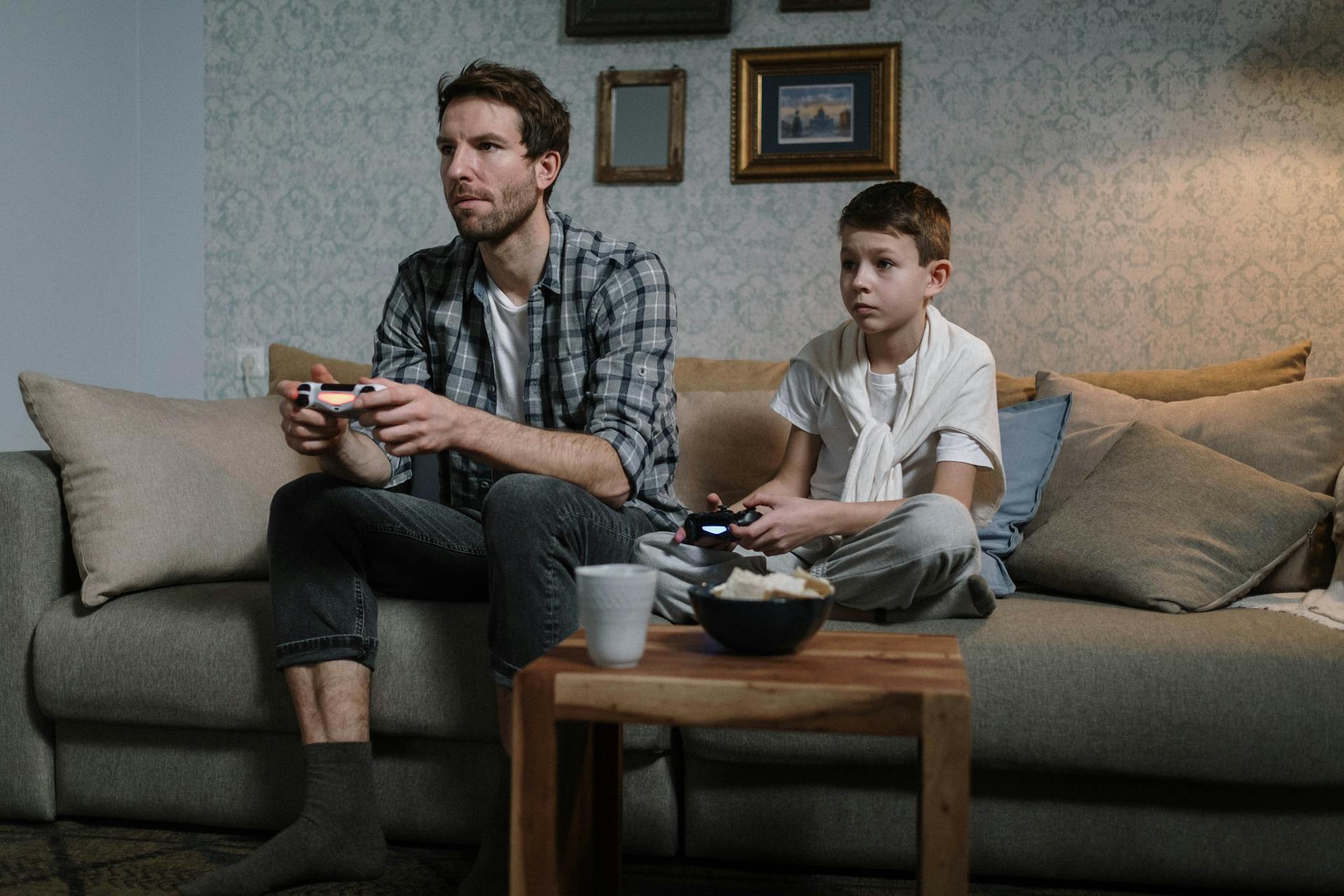 Dad and son playing video game | Source: Pexels
