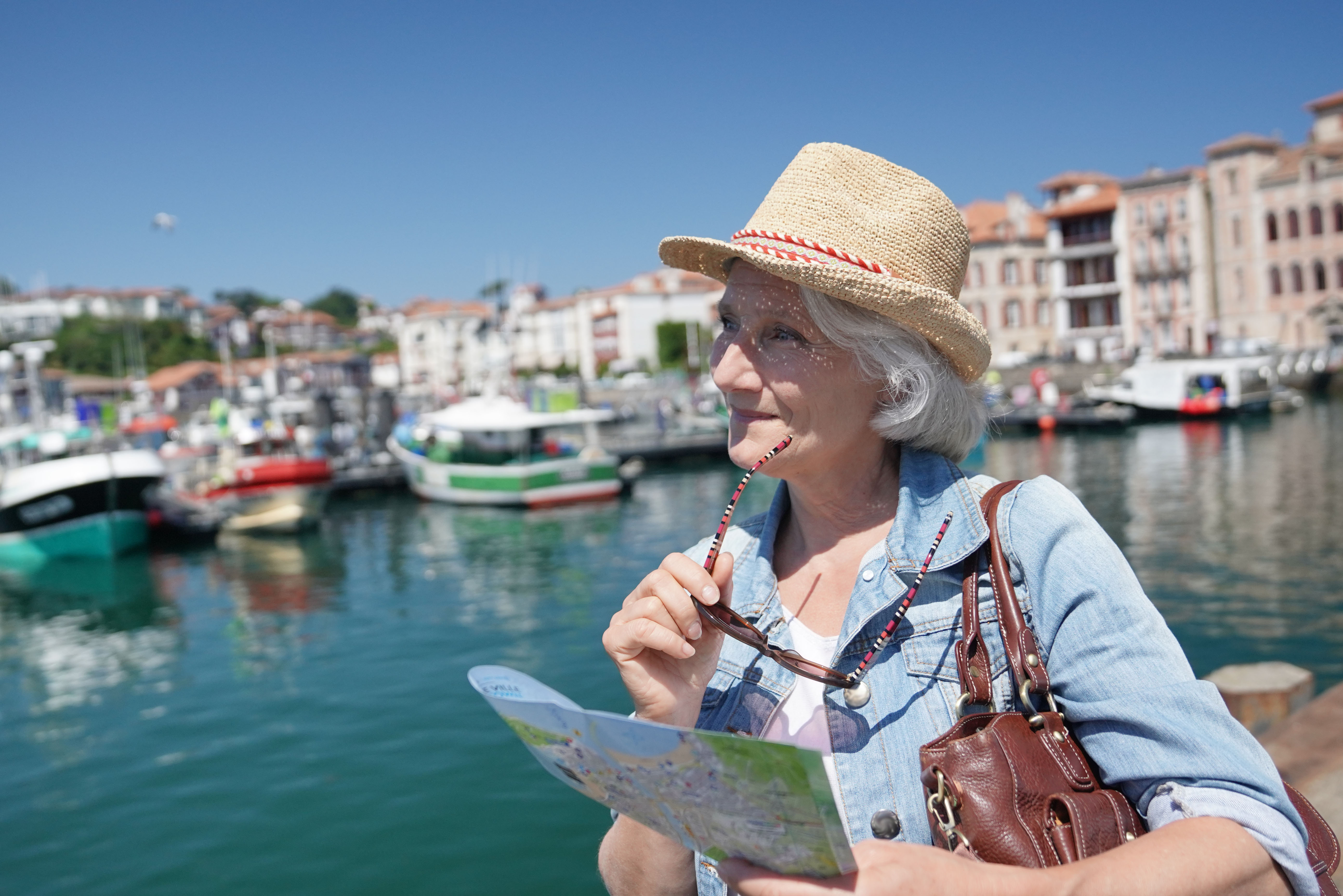 Senior woman visiting a touristic town | Source: Shutterstock