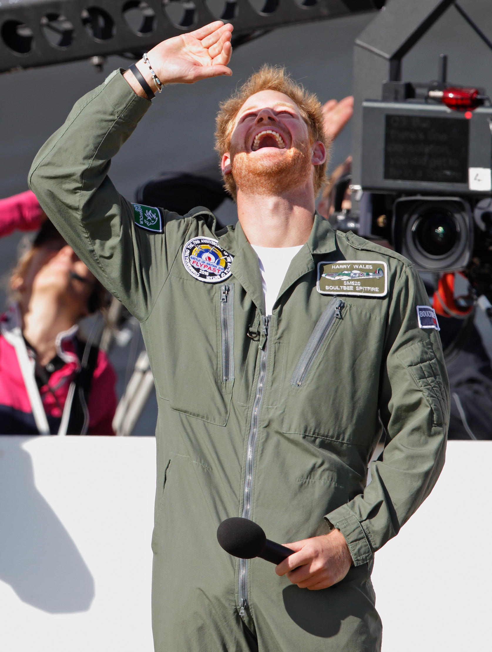 Prince Harry watches a Battle of Britain Flypast of Spitfire and Hurricane aircraft at Goodwood Aerodrome on September 15, 2015 in Chichester, England. | Source: Getty Images