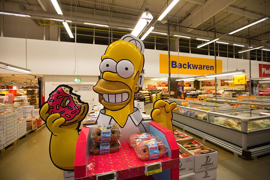A doughnut promotion stand featuring cartoon character Homer Simpson inside a Metro AG Cash & Carry wholesale store in Duesseldorf, Germany | Source: Getty Images