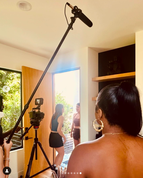 Alysha Burney directing/watching on as a scene from her movie "Hot Girl Getaway" takes place with two actresses, posted on July 22, 2024. | Source: Instagram/alyshaburney_