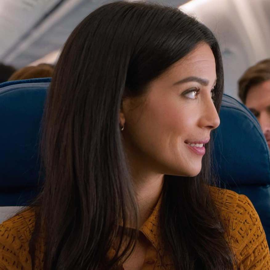 A woman in conversation onboard a plane | Source: Midjourney