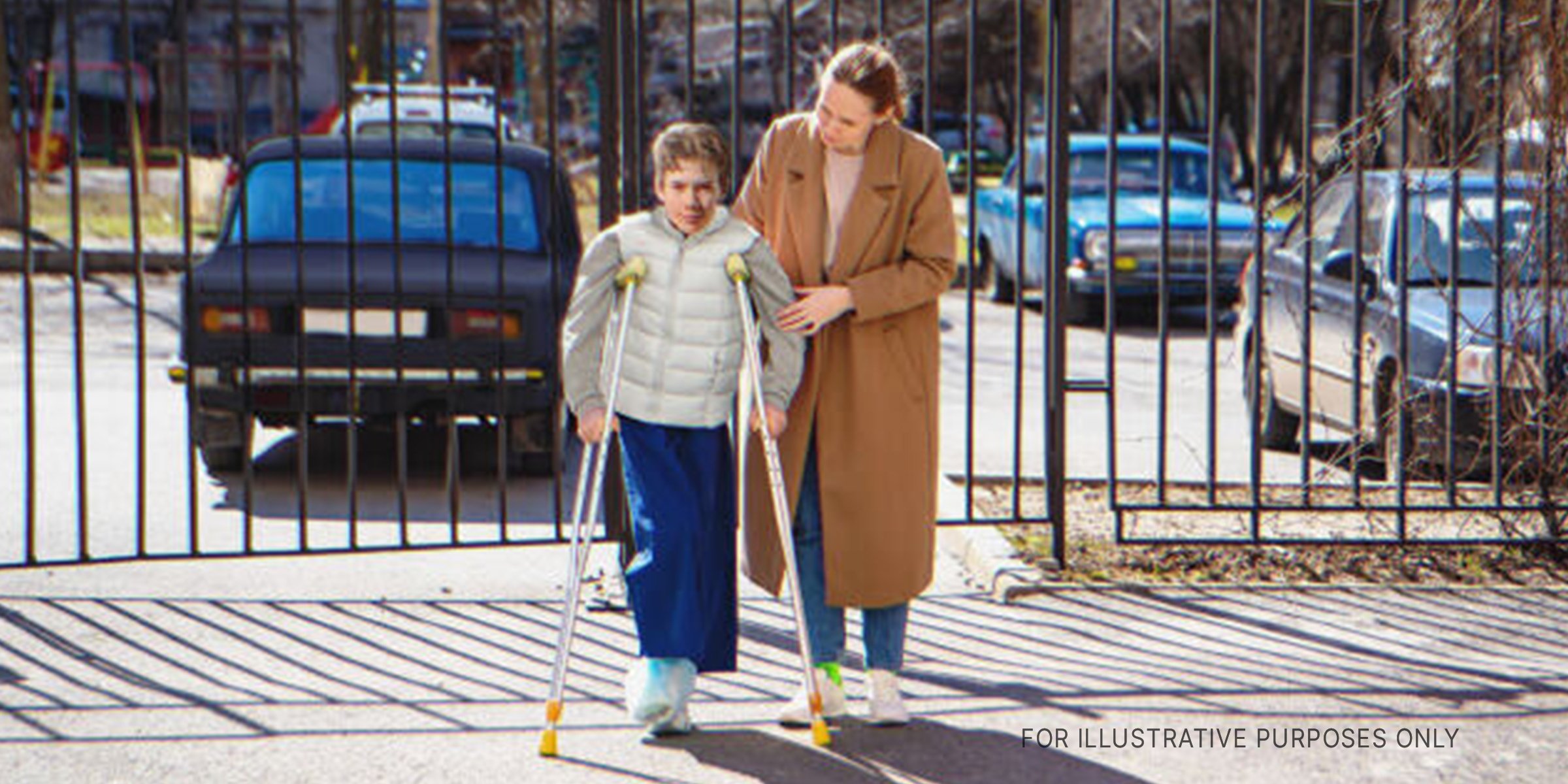 Woman helping boy on crutches. | Source: Getty Images 