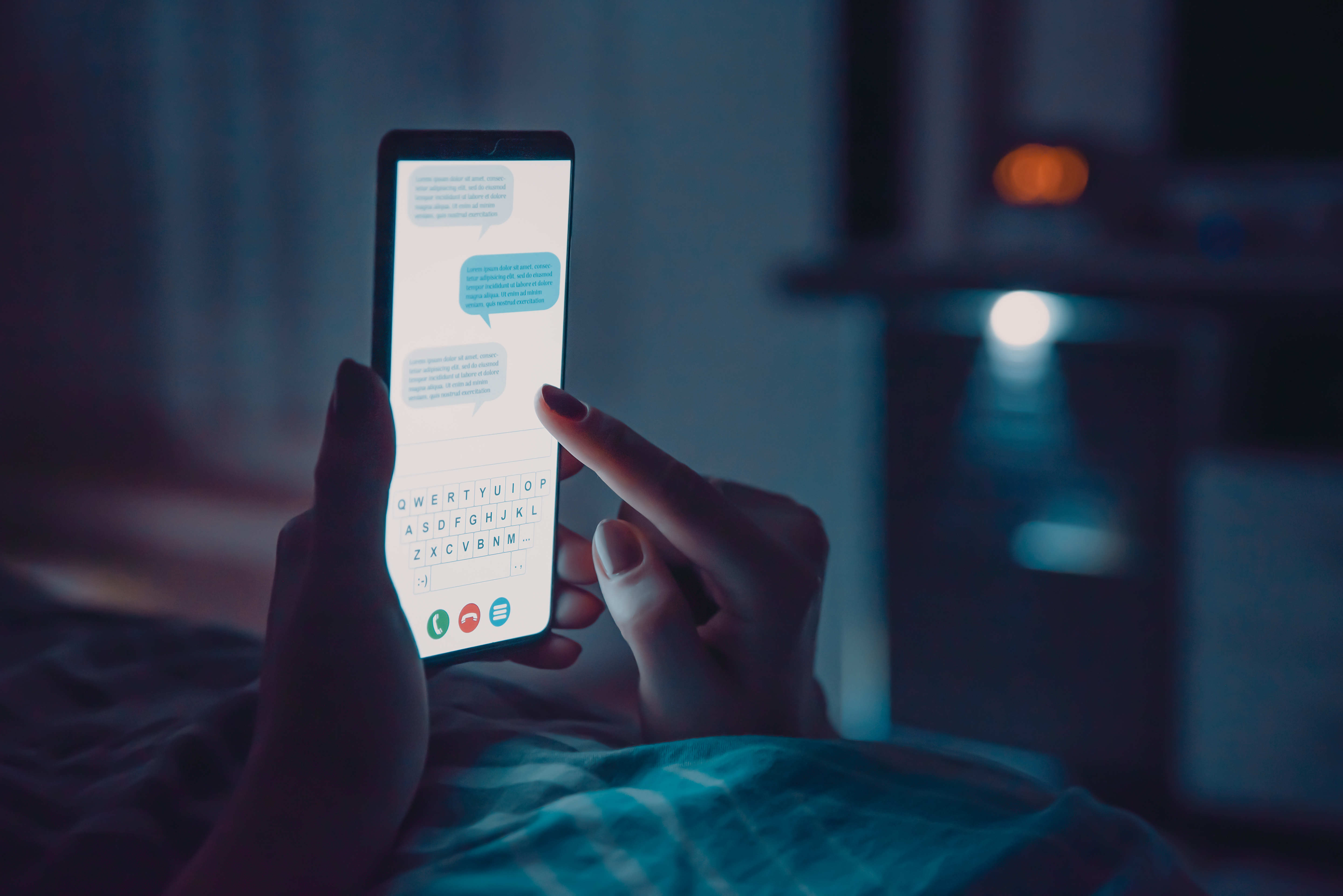 Woman lay in bed with smartphone before sleep | Source: Shutterstock