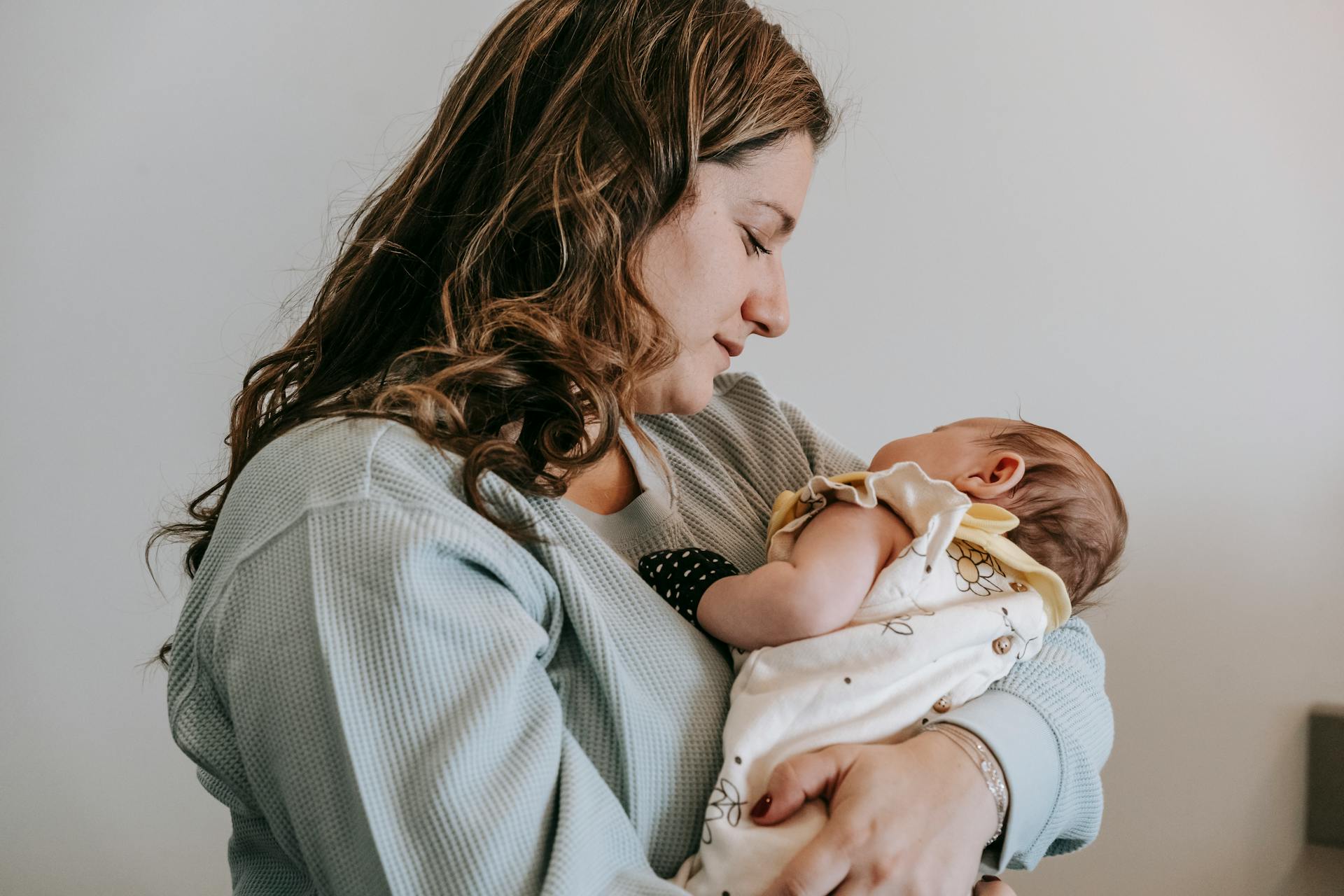 A happy mother smiling with her baby