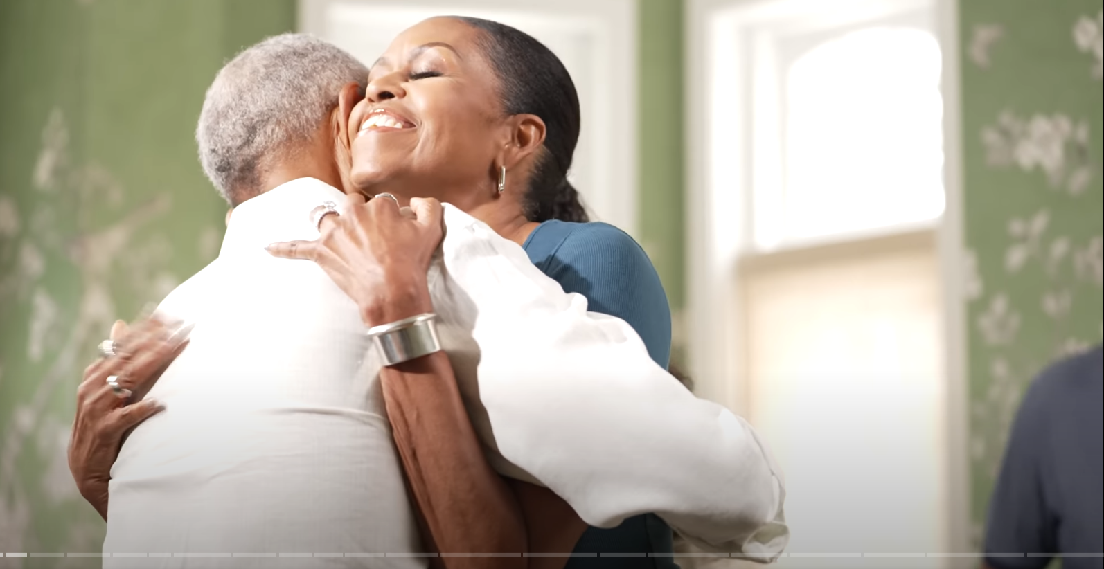 Barack and Michelle Obama in a tight embrace on the 'IMO with Michelle and Craig' podcast. From a video dated July 16, 2025. | Source: YouTube/Michelle Obama