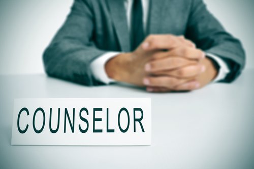 A man with counselor signage on his desk. | Source: Shutterstock.