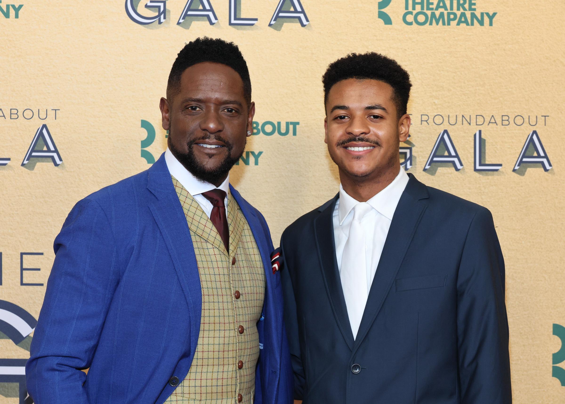 Blake Underwood stands beside his father, Blair Underwood, with a relaxed, confident smile, his facial features in clear view, revealing a strong and striking resemblance between the two.