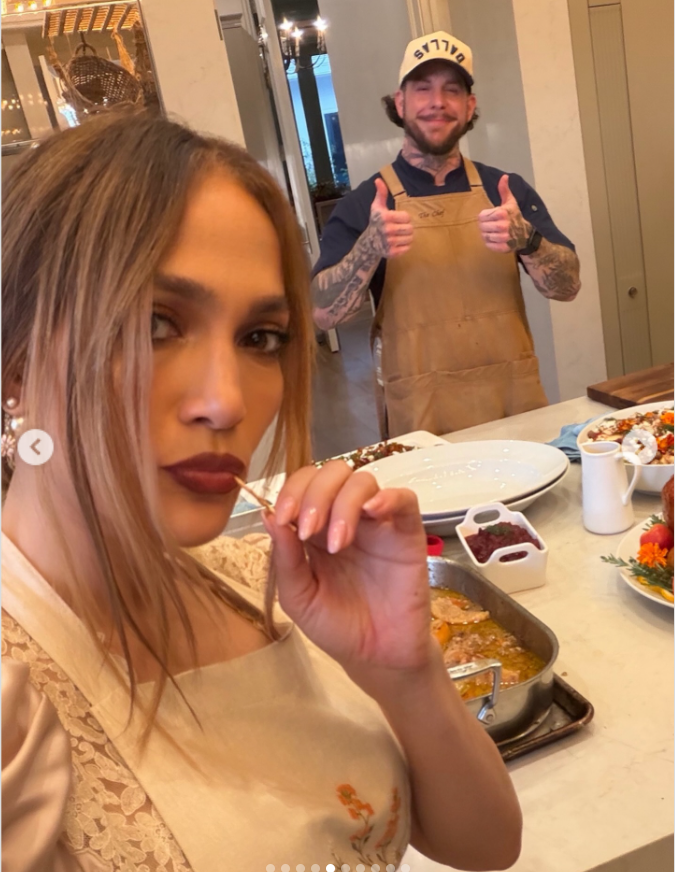 Jennifer Lopez in an apron takes a photo with a man who is also wearing an apron, as seen in a post dated November 28, 2025. | Source: Instagram/jlo