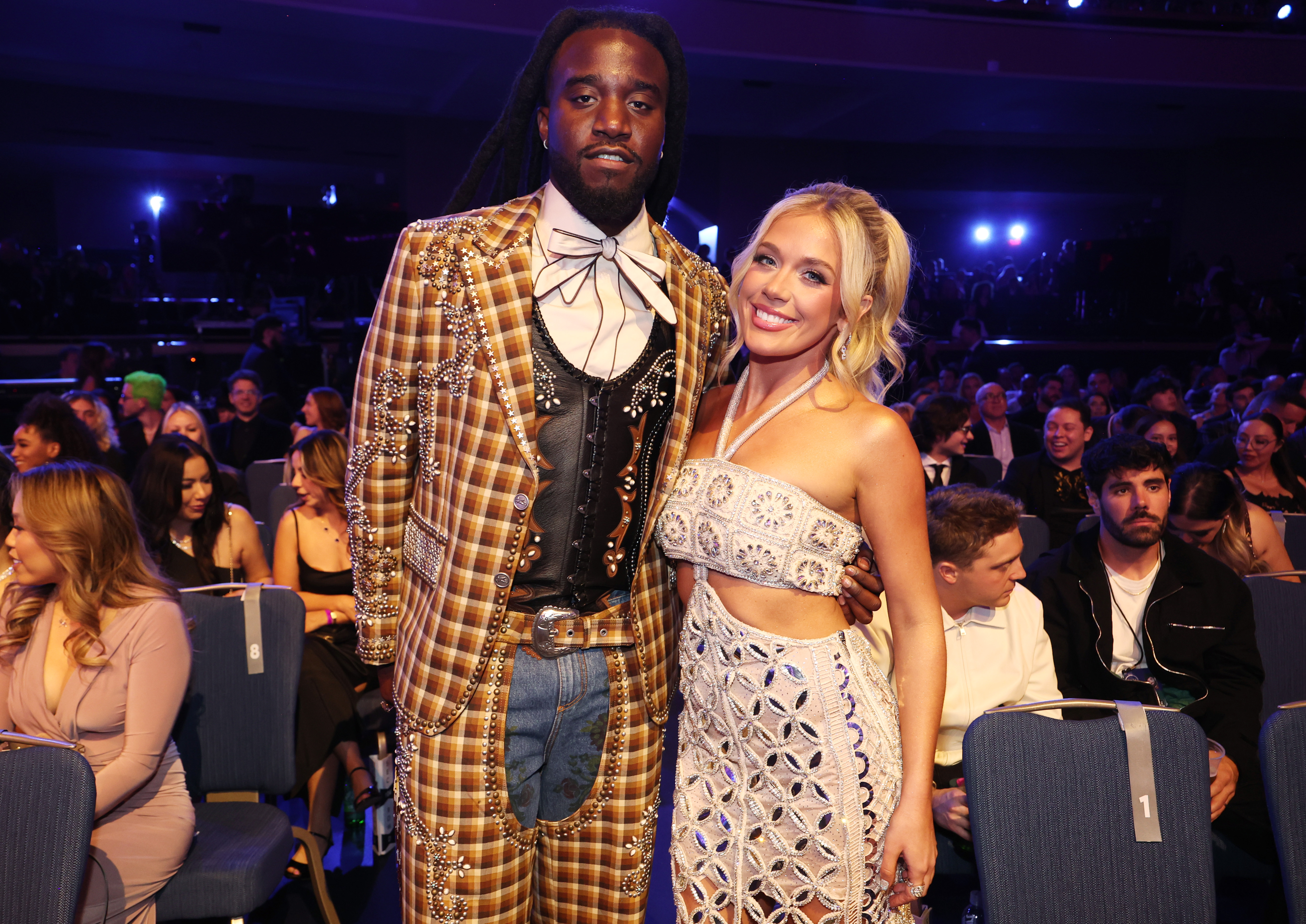 In the audience, she poses with flair next to Shaboozey dressed in an embellished Western-style suit, capturing a fashion-forward collision of styles.