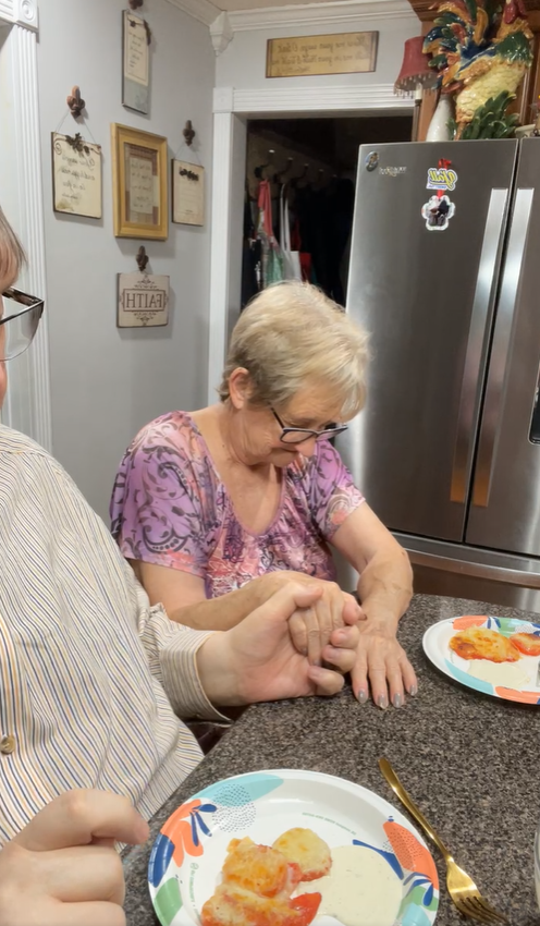 Before eating, John and his mother paused to pray together at the kitchen table. It was a familiar moment for regular viewers who often watched the pair share both recipes and faith. | Source: Facebook/coffeetimewithjohnandmomma