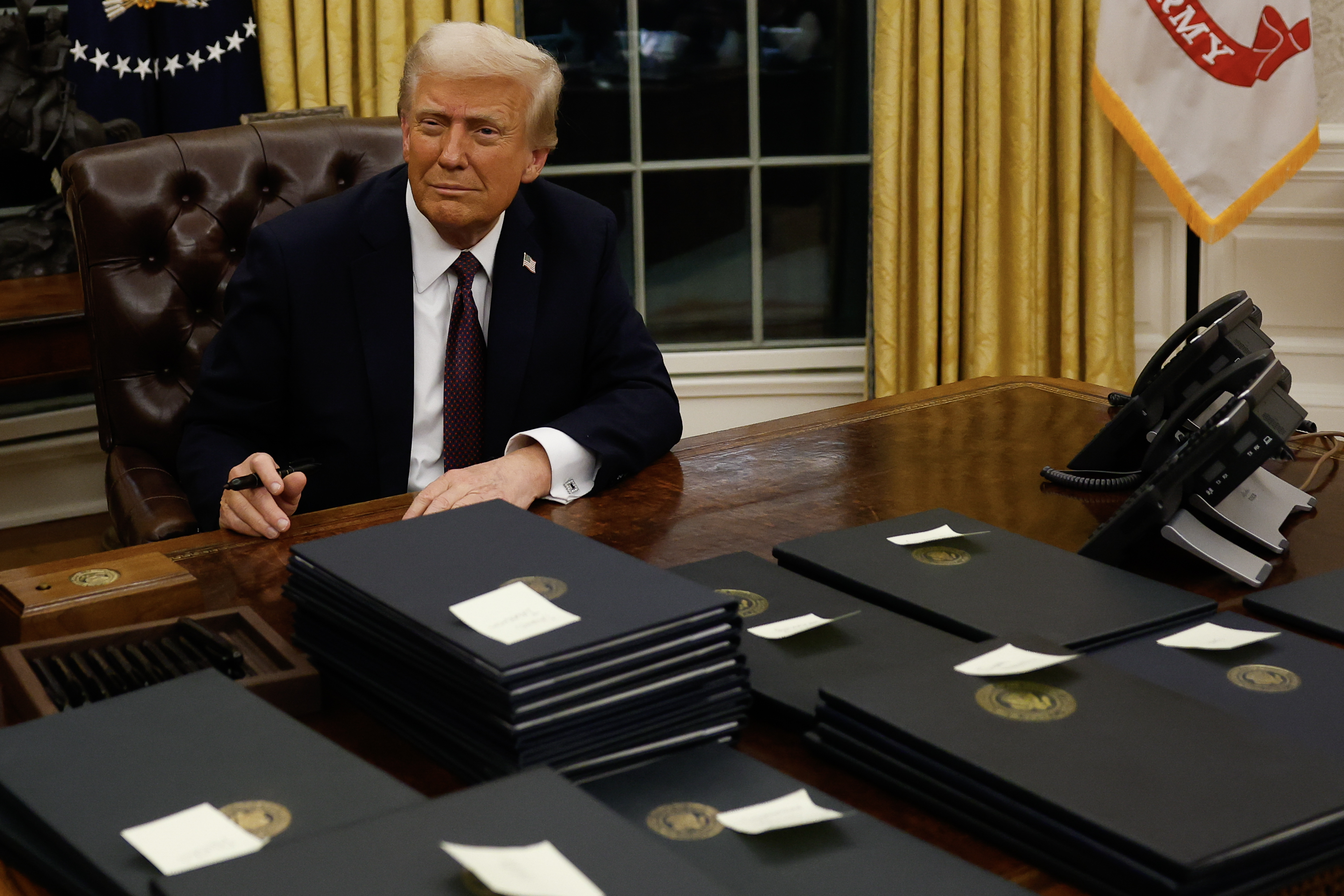 President Donald Trump signs executive orders in the Oval Office on January 20, 2025, in Washington, DC. | Source: Getty Images