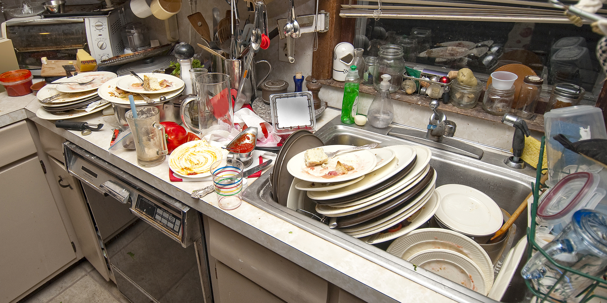A sink loaded with dirty dishes | Source: Shutterstock