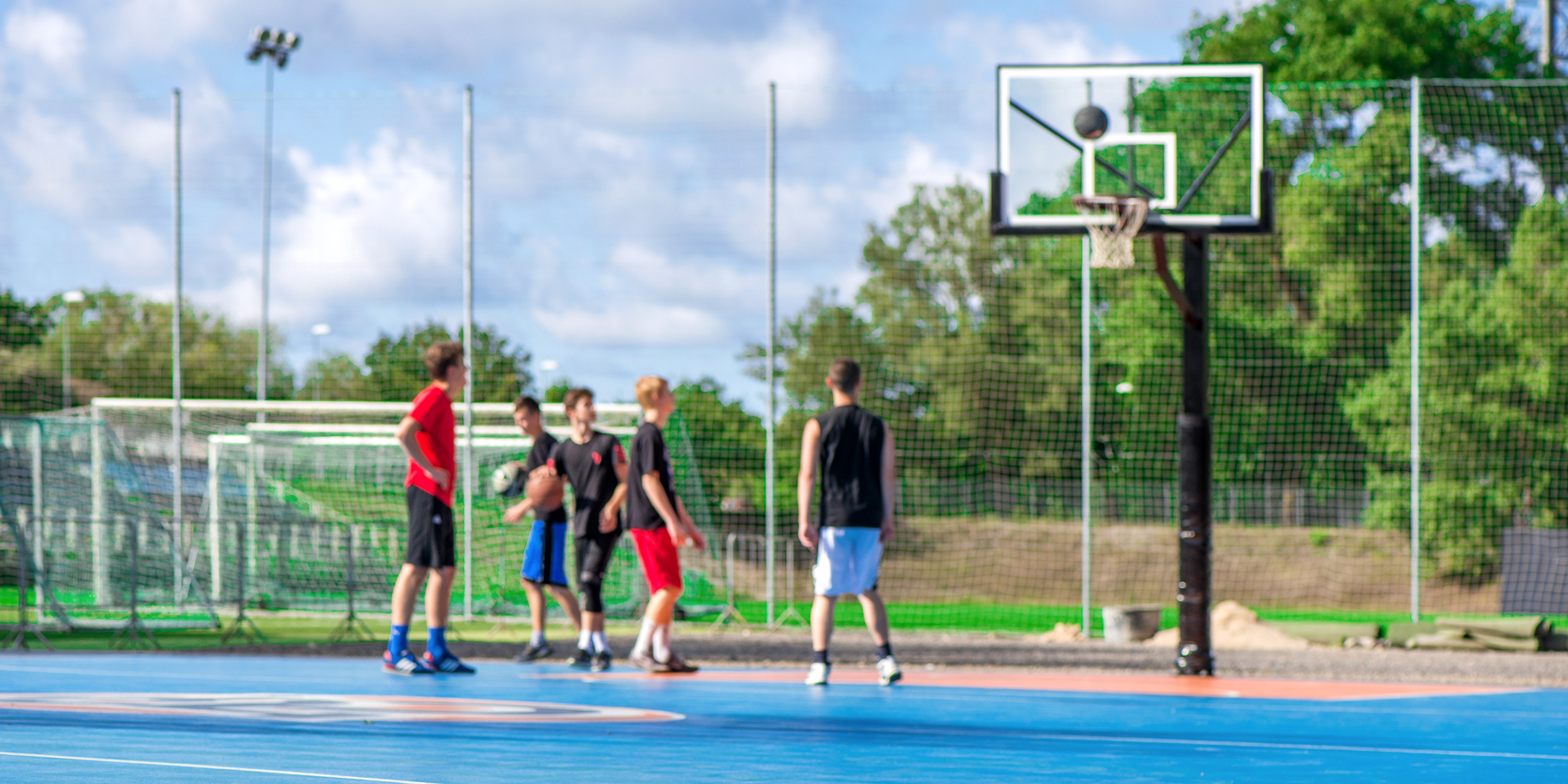 Some school boys playing basketball | Source: Shutterstock