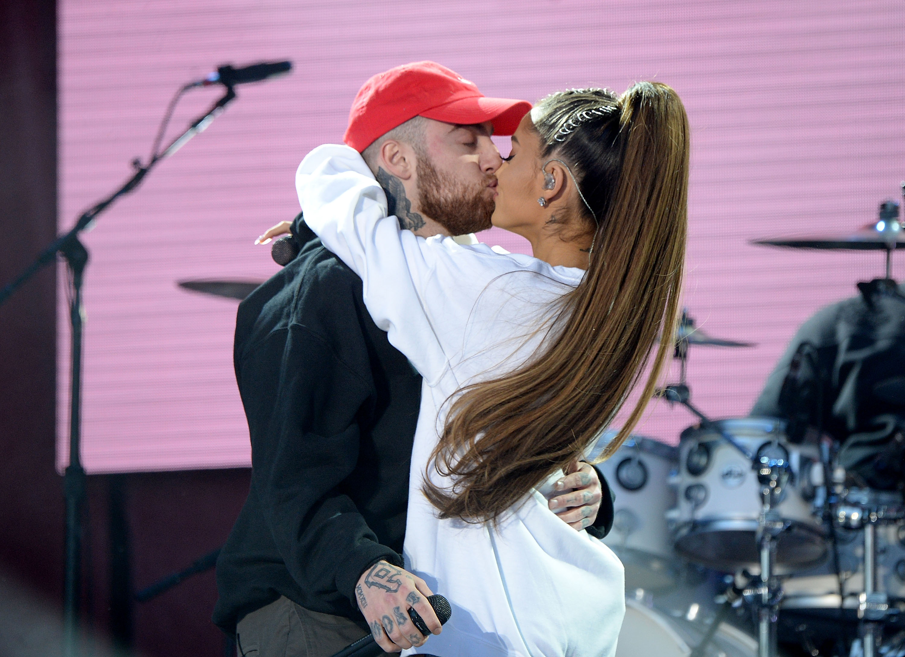 Mac Miller and Ariana Grande kiss on stage during the One Love Manchester Benefit Concert at Old Trafford Cricket Ground on June 4, 2017 in Manchester, England | Source: Getty Images