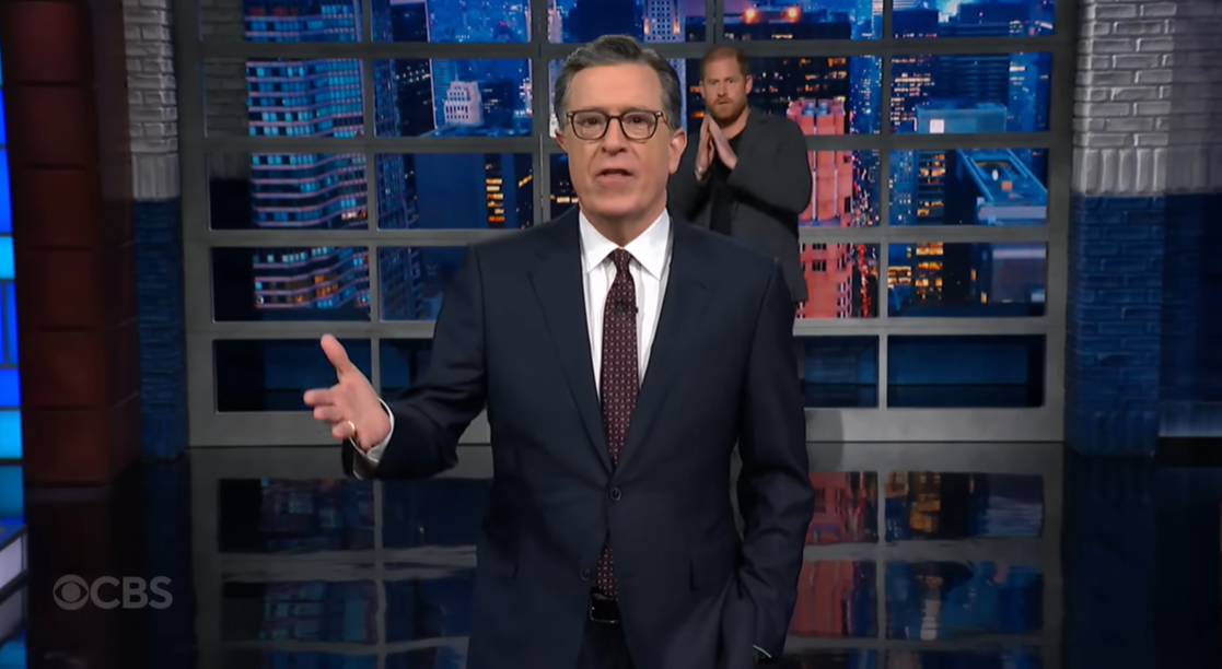 Stephen Colbert speaks during his monologue as Prince Harry quietly approaches from behind, as posted on December 4, 2025 | Source: YouTube/ColbertLateShow