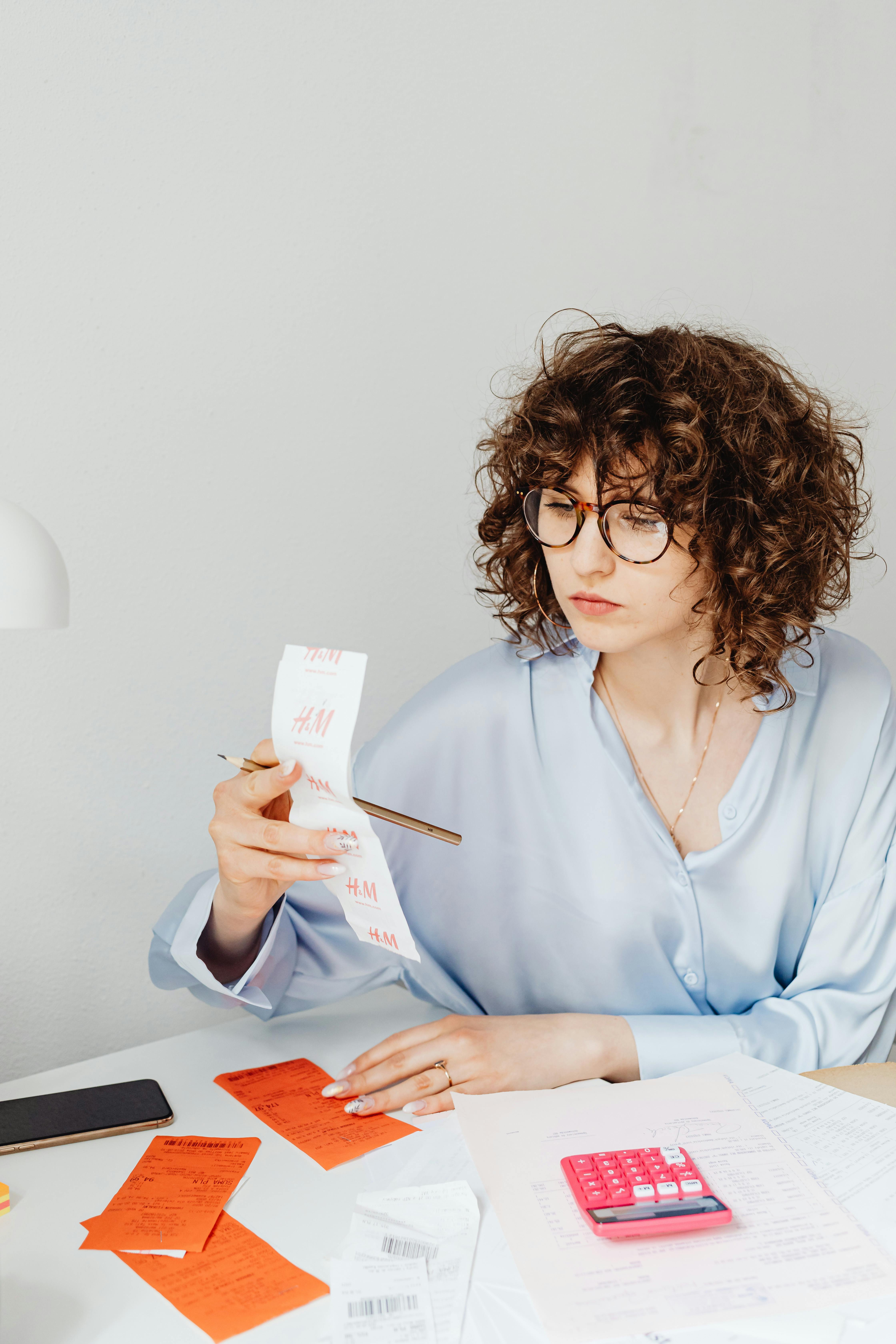 A concerned woman looking over receipts | Source: Pexels