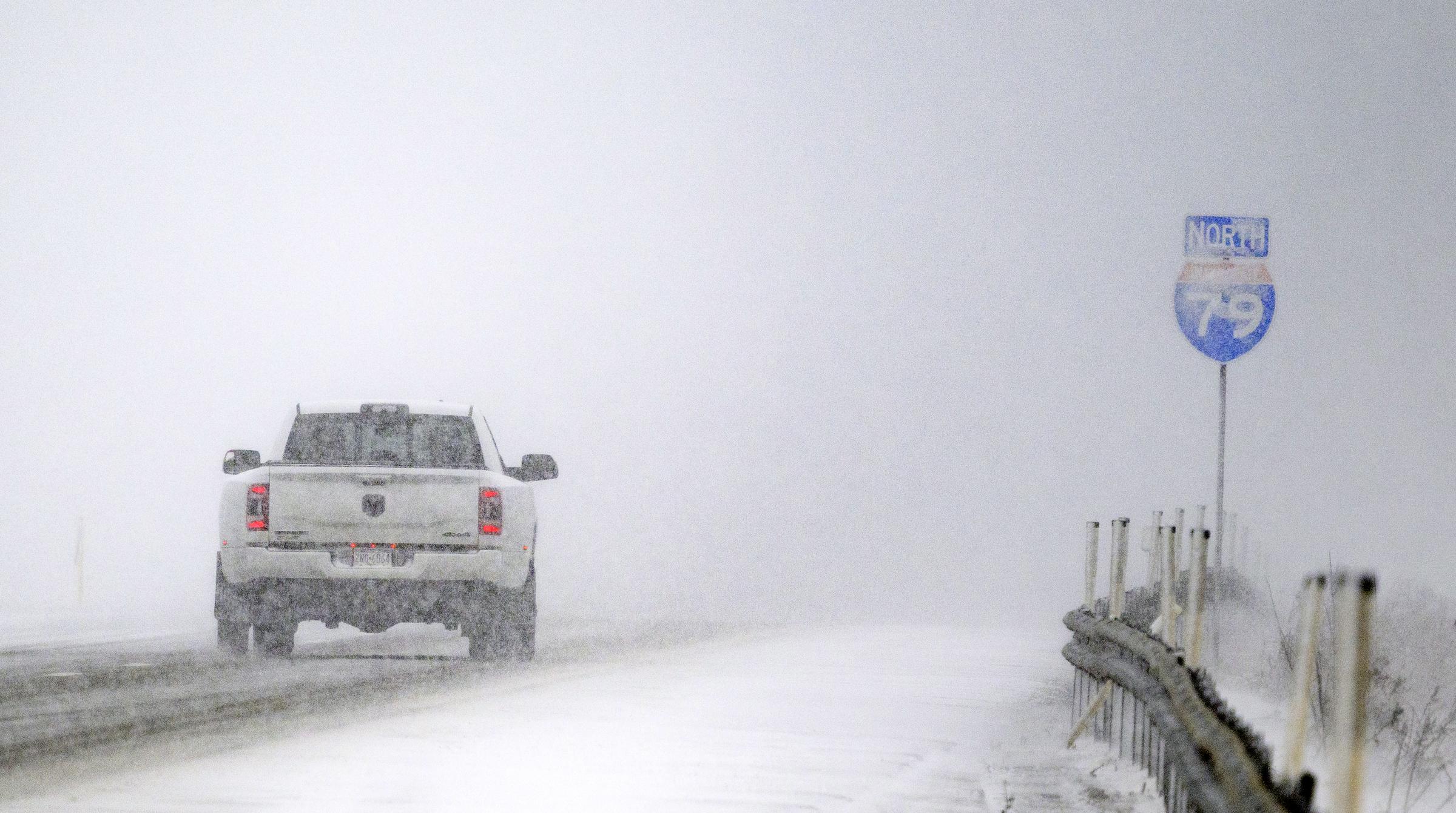 Cars navigate whiteout snow on I-79 in Erie, Pennsylvania, on December 12, 2024 | Source: Getty Images