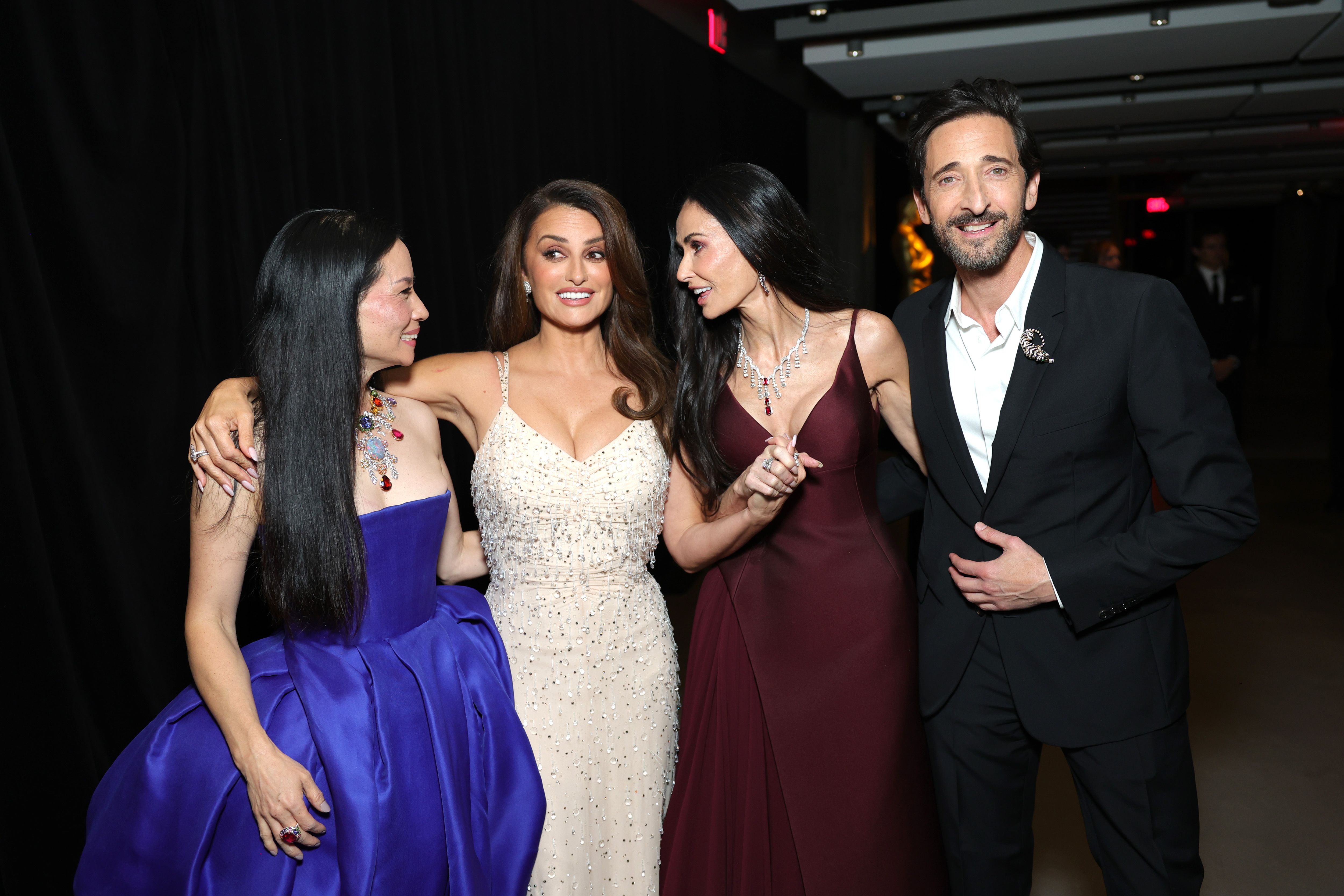 Arm in arm with Lucy Liu and Penélope Cruz, Demi Moore laughs mid-conversation as they greet Adrien Brody — a candid, star-studded snapshot of chemistry and charisma on the gala’s glittering floor.