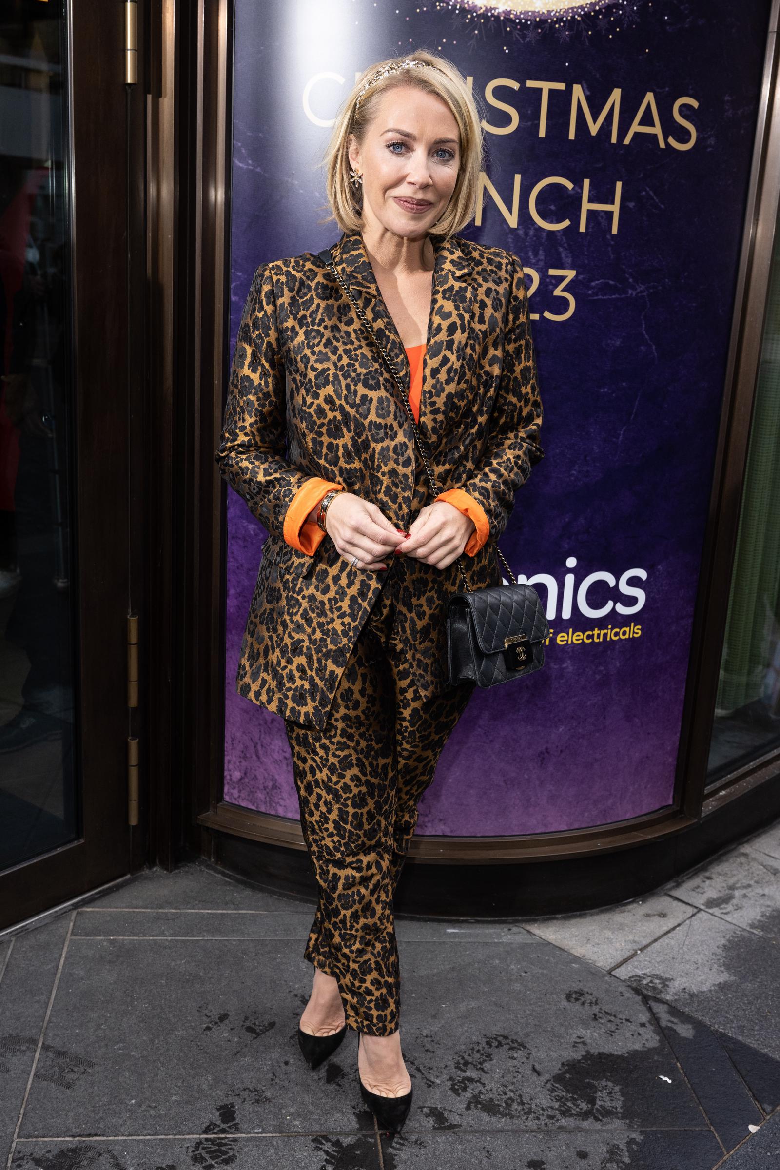 Unleashing her wild side! Hamilton roars onto the red carpet at the TRIC Christmas Lunch on 5 December 2023, commanding attention in a fierce leopard-print suit with vivid orange cuffs and a stylish quilted crossbody.