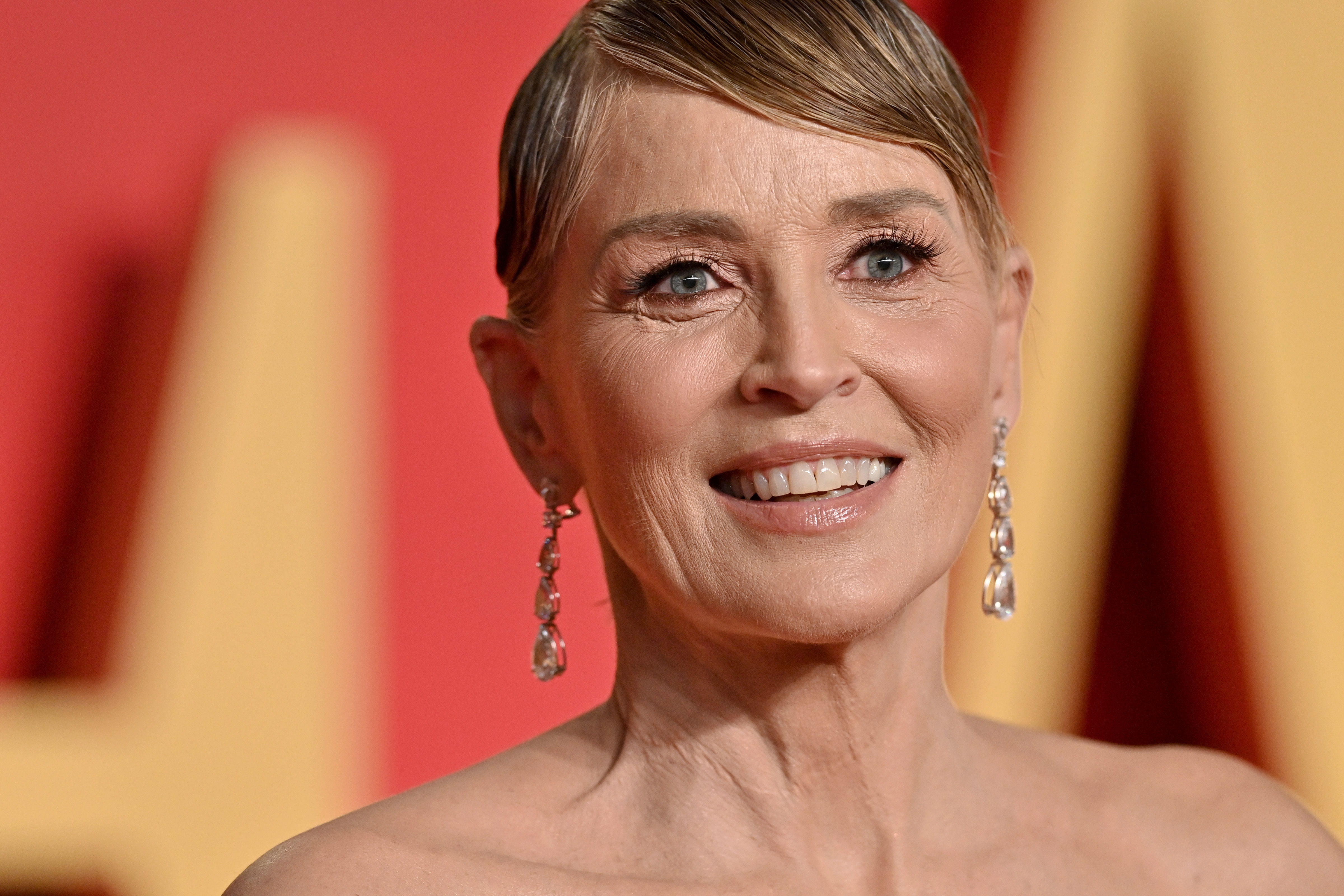 Sharon Stone strikes an elegant pose in a flowing pastel ensemble, showcasing her signature poise and proving that sophisticated style never goes out of fashion.
