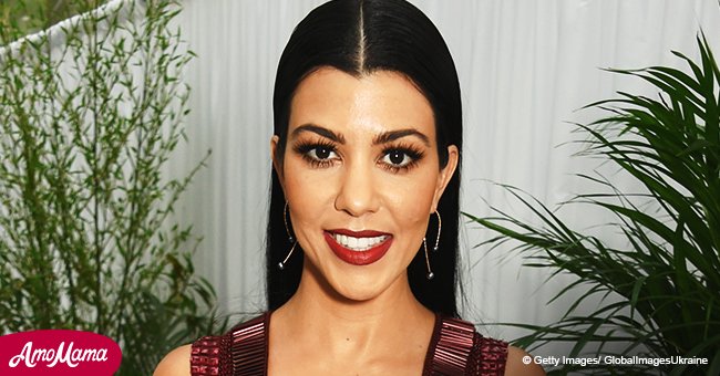 Kourtney Kardashian puts her cleavage on display in a nude tank top while out on a family trip