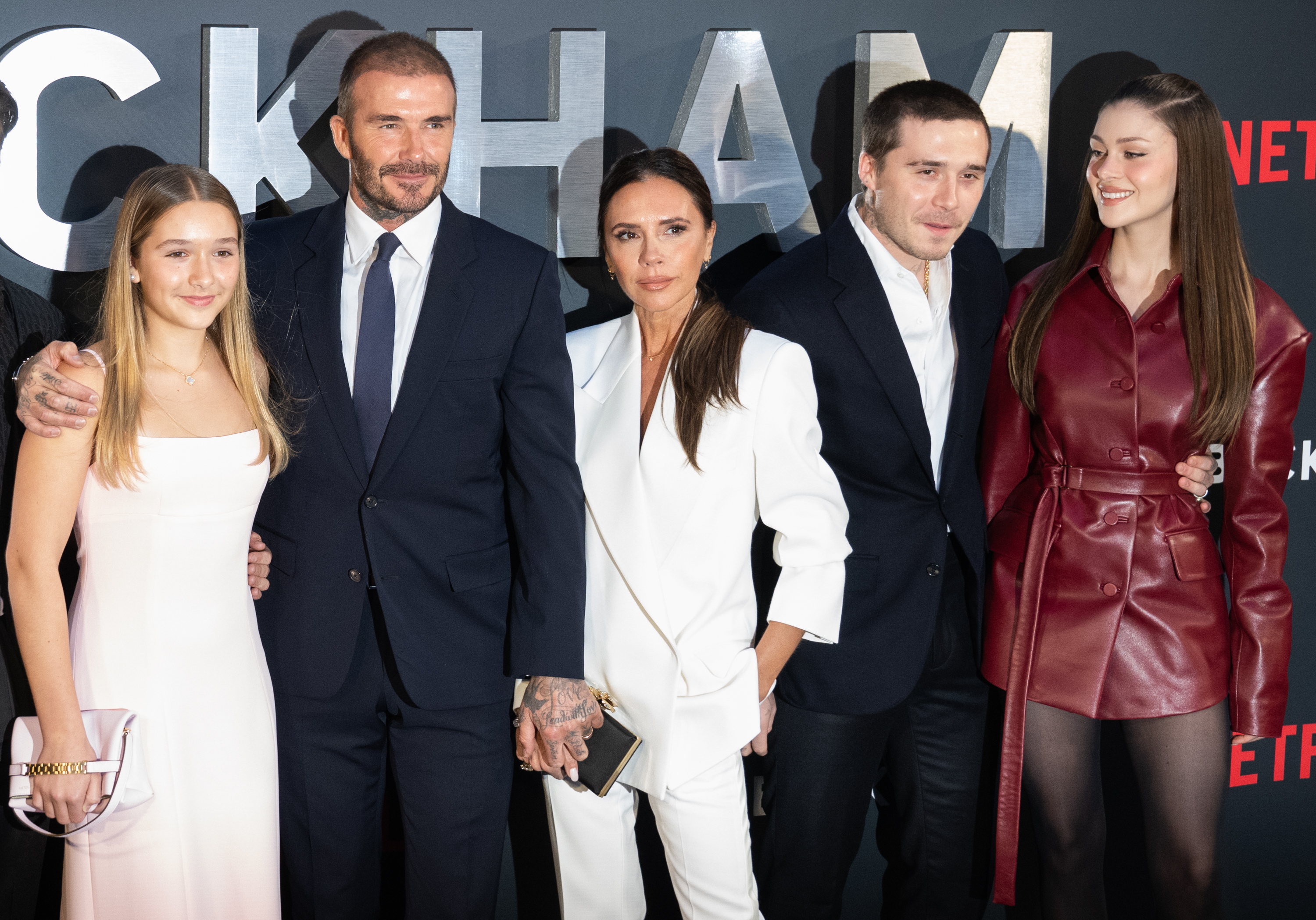 Harper, David, and Victoria Beckham with Brooklyn and Nicola Peltz Beckham at the Netflix "Beckham" UK premiere on October 3, 2023, in London, England. | Source: Getty Images