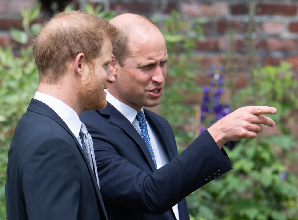 Prince William and Prince Harry look at a statue they commissioned of their mother Diana, Princess of Wales, in the Sunken Garden at Kensington Palace on July 1, 2021 in London | Photo: Getty Images