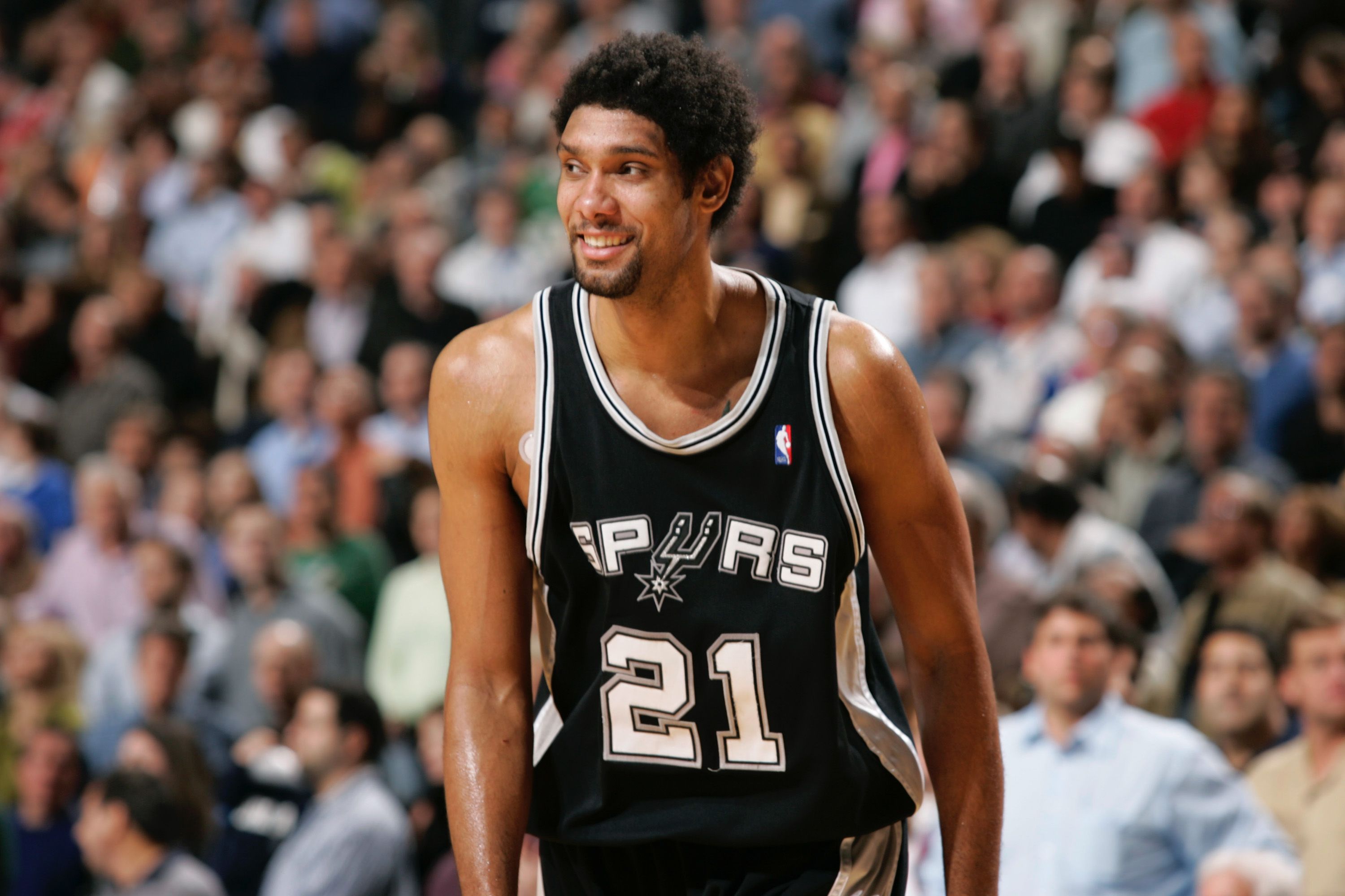 Tim Duncan smiles after his team pulled out a 92-90 win against the Dallas Mavericks on December 1, 2005 at American Airlines Center in Dallas, Texas. | Source: Getty Images