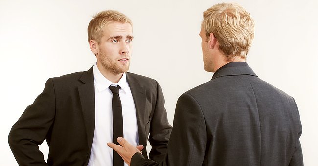 A man in a suit looks concerned while talking to another man. | Photo: Getty Images