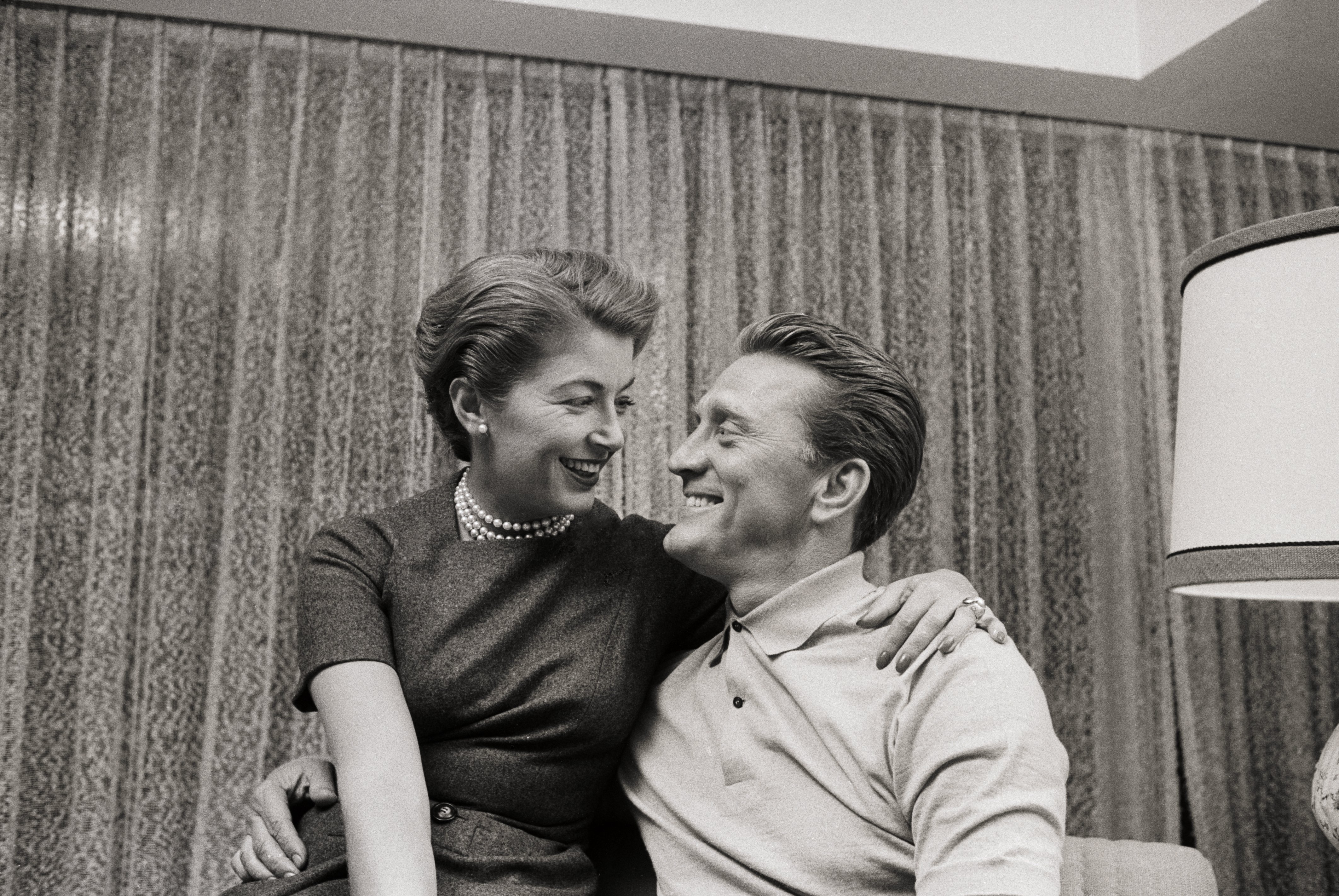 Kirk Douglas and his spouse Anne Douglas gaze at each other in a portrait photo. | Source: Getty Images