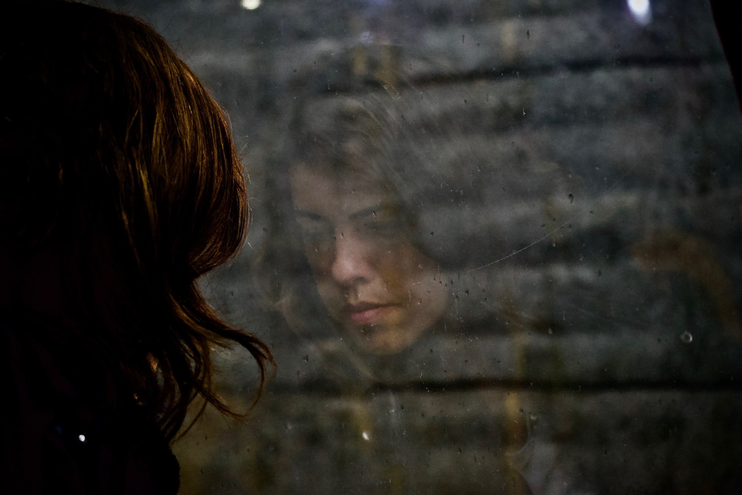 A woman standing near a window. | Source: Unsplash