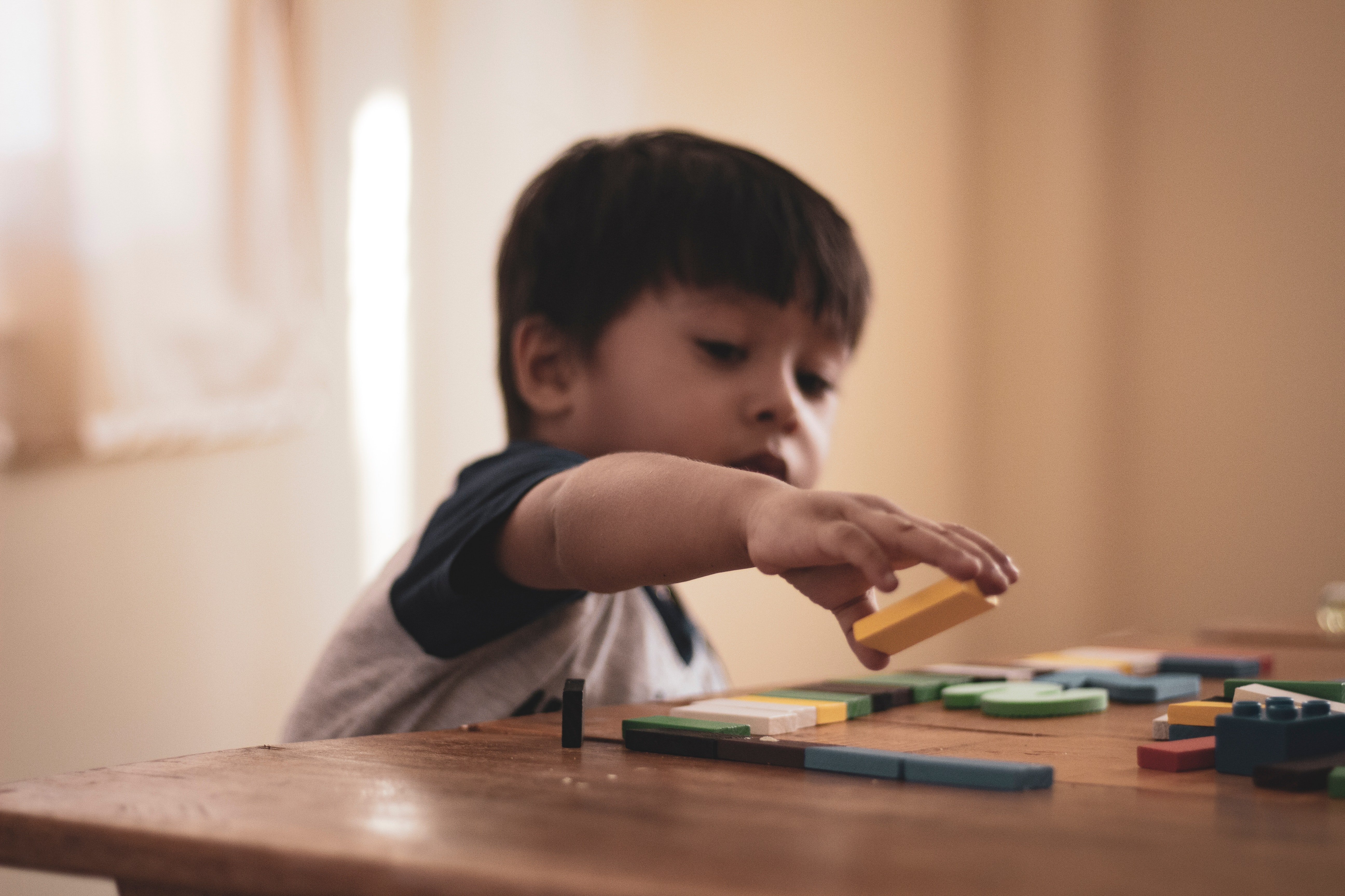 Kid playing with wooden blocks. | Source: Pexels