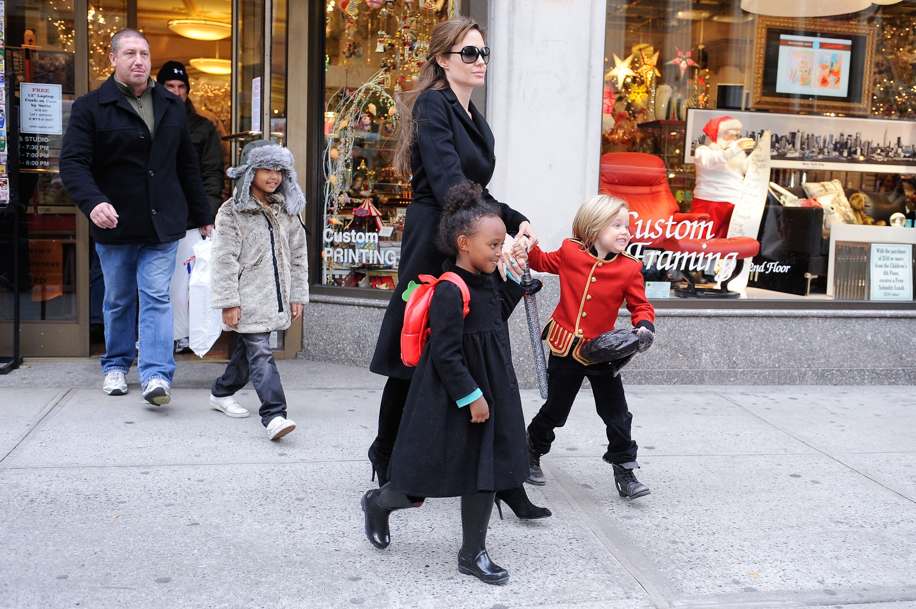 Maddox Jolie-Pitt, actress Angelina Jolie, Zahara Jolie-Pitt, and Shiloh Jolie-Pitt shopping in 2010 in New York City | Source: Getty Images