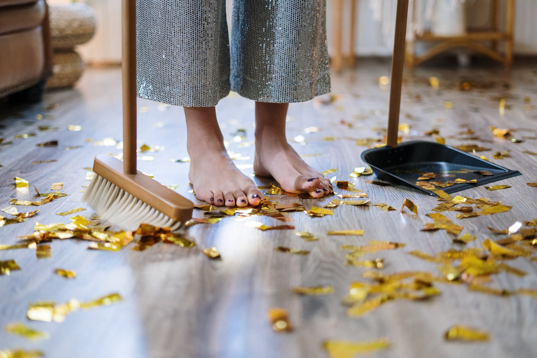 Woman sweeping confetti | Source: Pexels