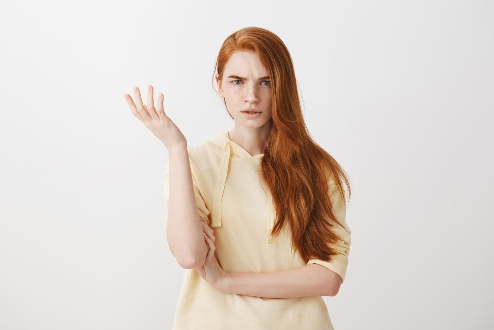 Angry red-haired teenager being rude to an adult. | Photo: Shutterstock.