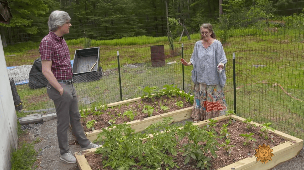 Melissa Gilbert showing CBS correspondent Mo Rocco her plant bed at her farm house in Livingston County. | Source: YouTube/OWN