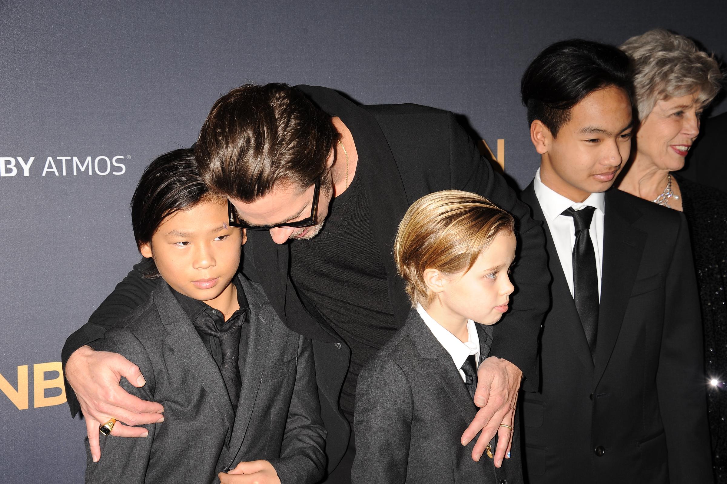Pax, Shiloh, and Maddox Jolie-Pitt with Brad Pitt at the premiere of "Unbroken" in Hollywood on December 15, 2014. | Source: Getty Images