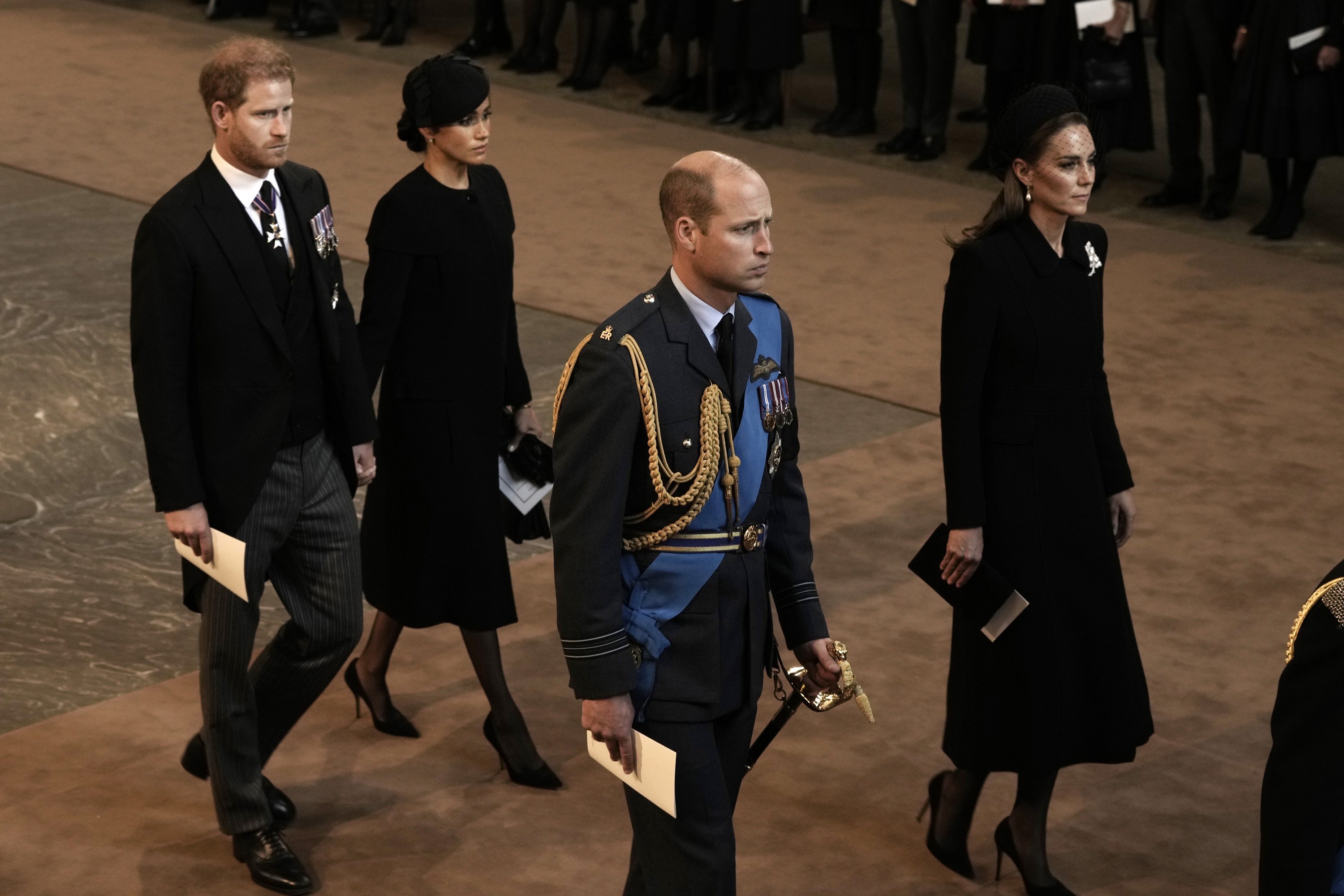 Prince Harry, Duke of Sussex and Meghan, Duchess of Sussex, Prince William, Prince of Wales and Catherine, Princess of Wales walk behind the coffin as they arrive in The Palace of Westminster after the procession for the Lying-in State of Queen Elizabeth II on September 14, 2022 in London, England | Source: Getty Images 