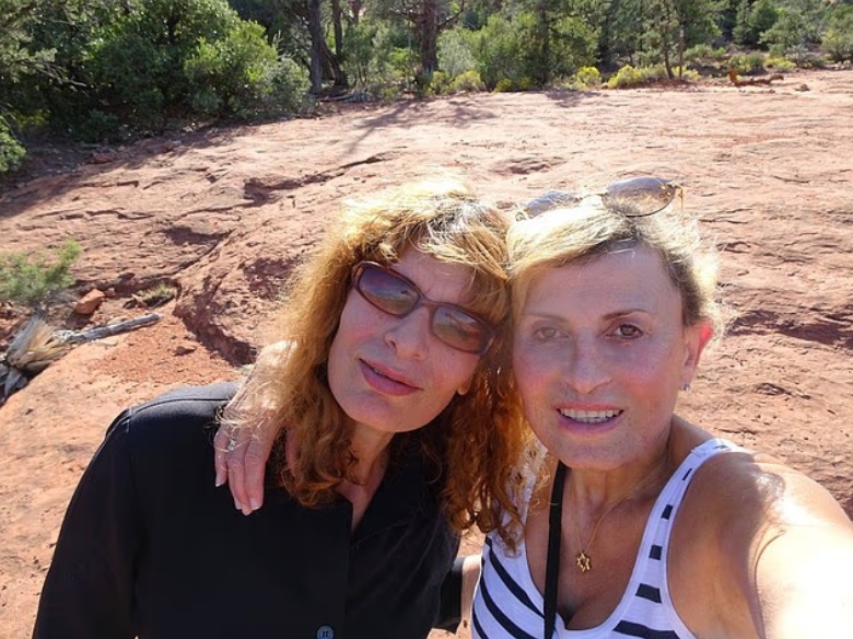 Jennifer Abbott and Nancy Pexton are pictured close together outdoors, posing for a selfie in a sunlit landscape. | Source: X/TrueCrimeUpdate