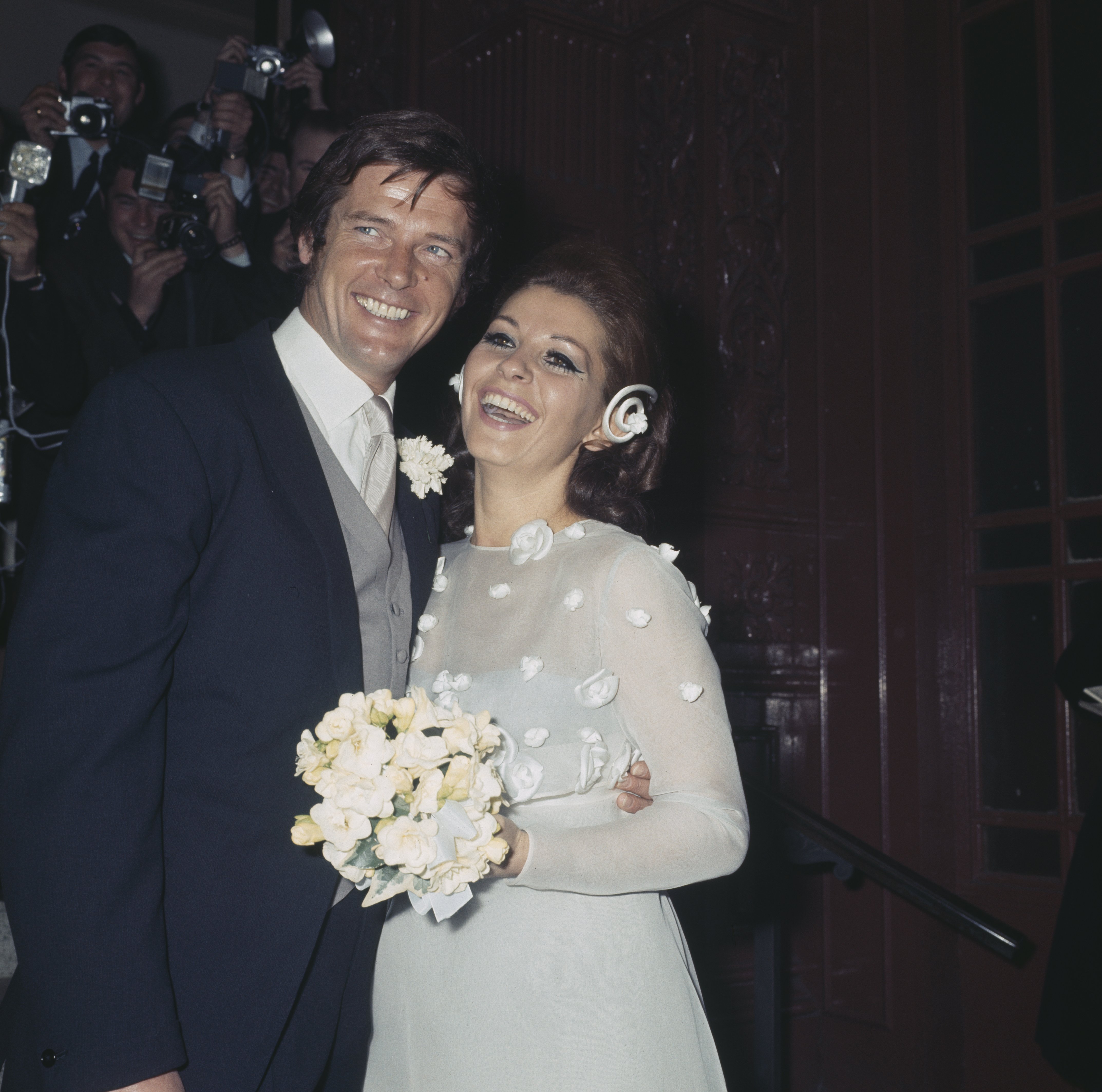 Actor Roger Moore pictured with his new wife, Italian actress Luisa Mattioli on their wedding day outside Caxton Hall in London on April 11, 1969 | Source: Getty Images