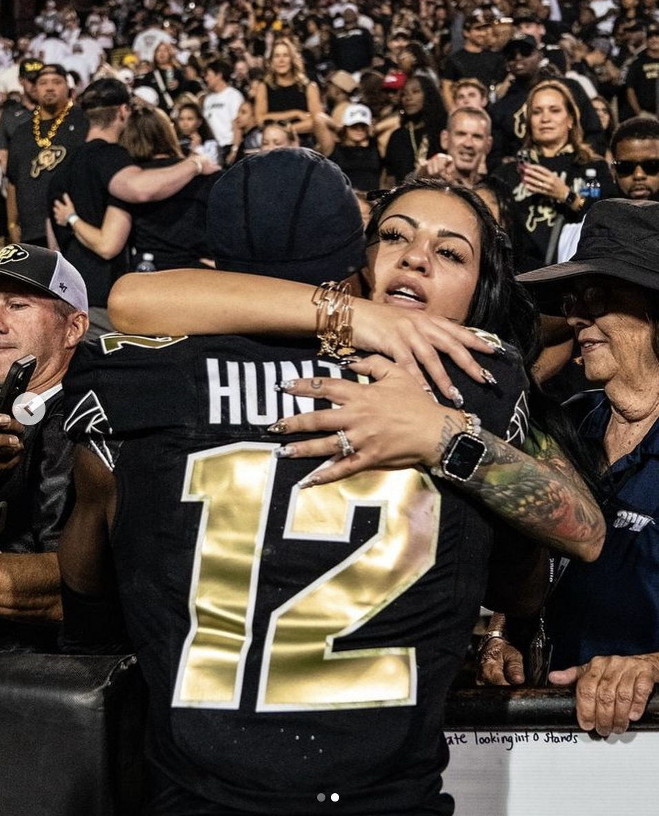 Travis Hunters hugging his fiancée, Leanna Lenee, in a photo shared on September 27, 2024 | Source: Instagram/db3_tip