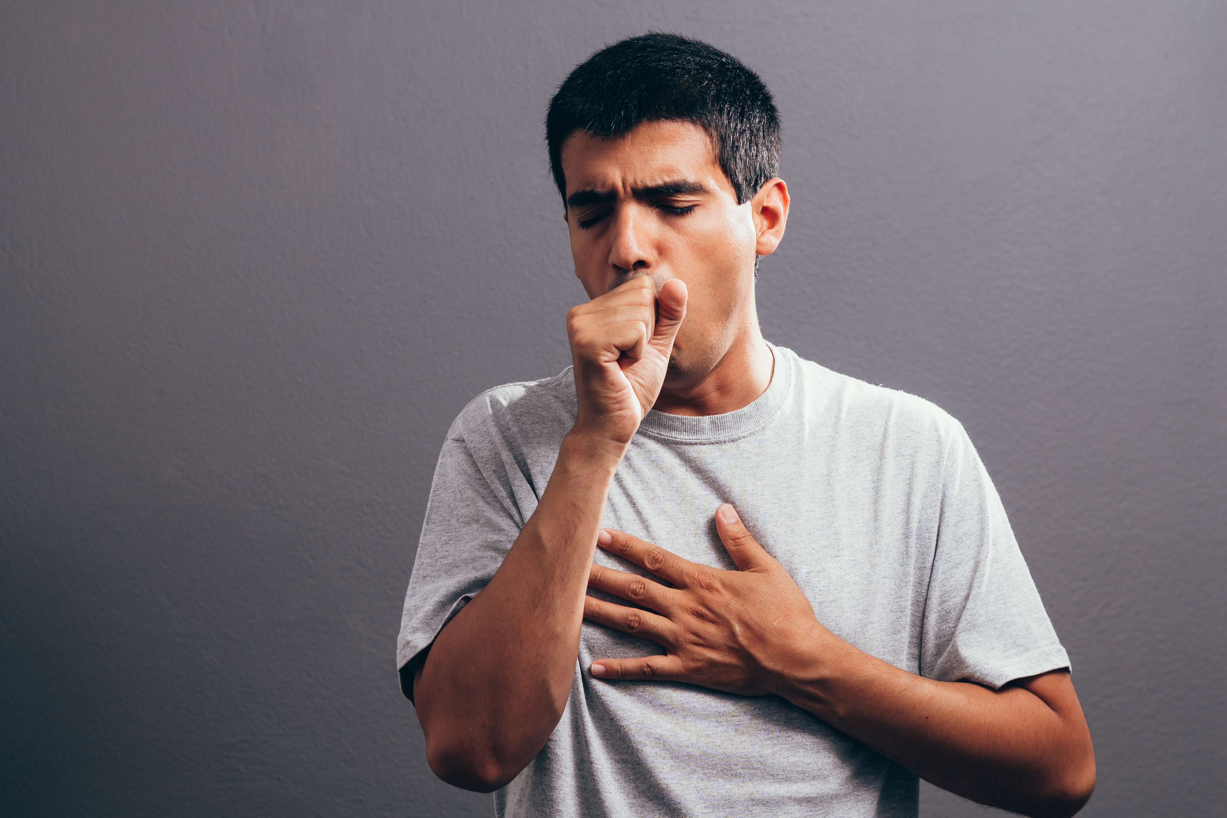 A person coughing. | Source: Shutterstock