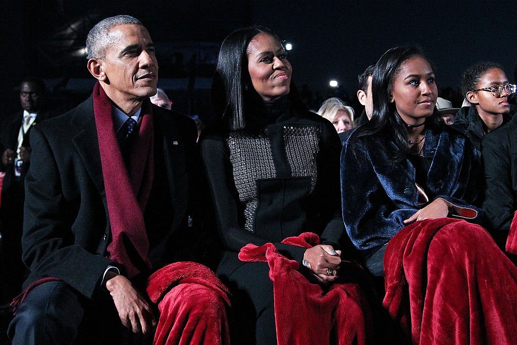 President Barack Obama sits with first lady Michelle Obama and their daughter Sasha to watch musical perfomances during the 94th Annual National Christmas Tree Lighting Ceremony on the Ellipse in PresidentÕs Park | Photo: Getty Images