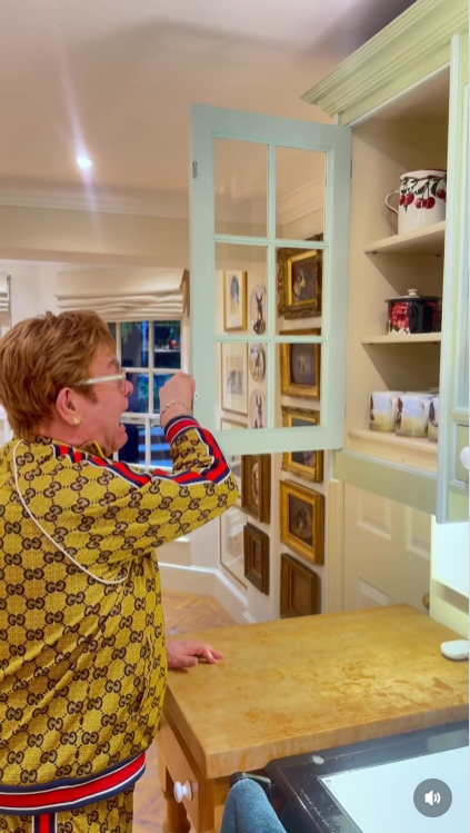 The moment the cabinet croons "Step Into Christmas," John lets out a full-bodied scream and snaps it shut — as if the only way to survive the season is to stop the song at the source. | Source: Instagram/eltonjohn