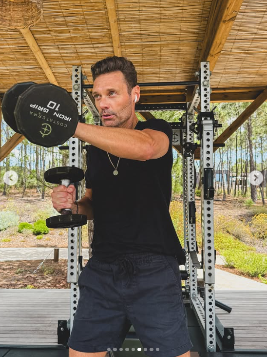 Ryan Seacrest lifts weights during an outdoor workout session, posted on June 30, 2025 | Source: Instagram/ryanseacrest